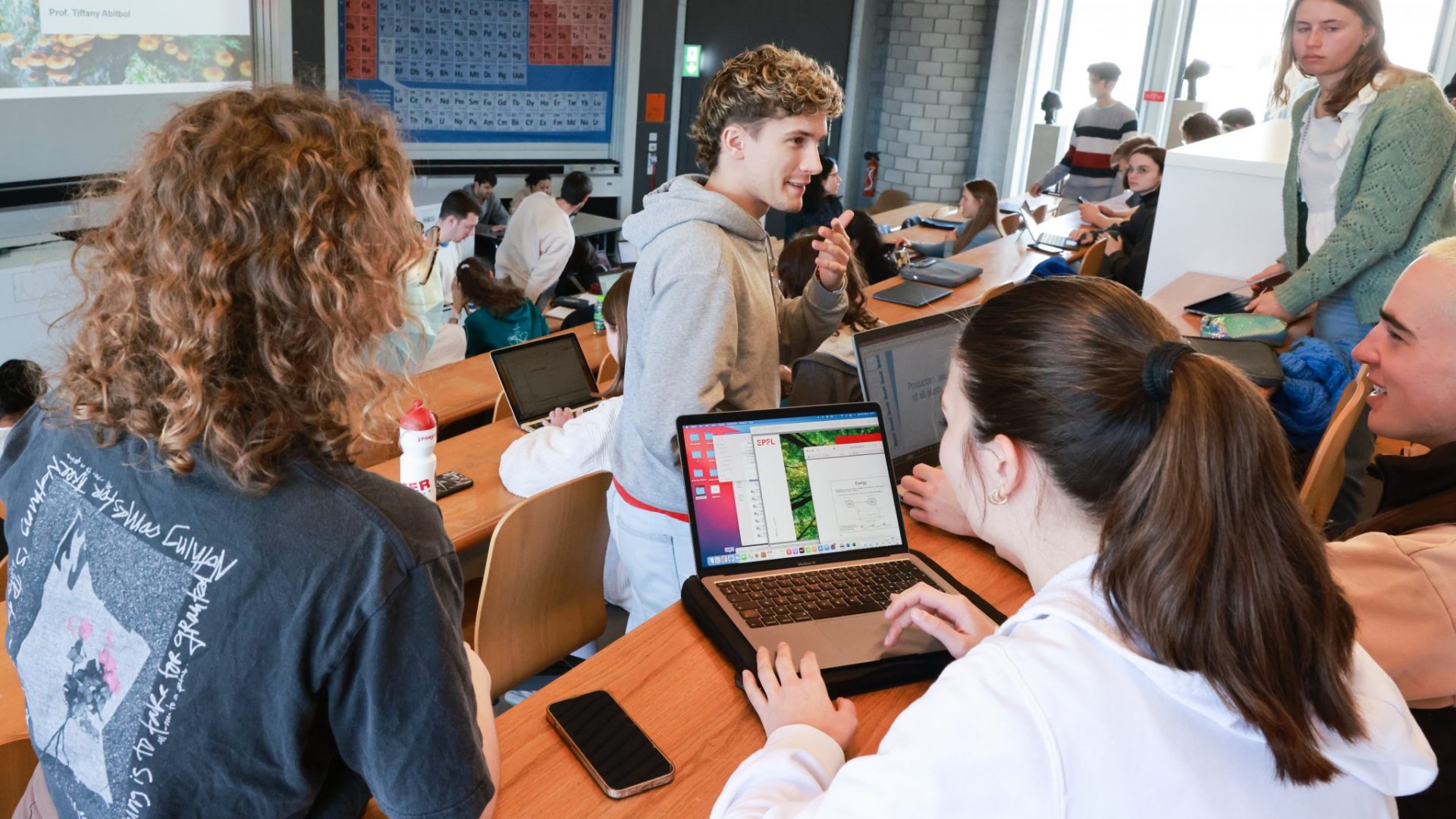 Des étudiantes et des étudiants discutant dans un auditoire de l'EPFL