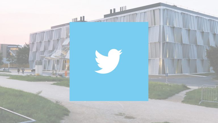 Logo de Twitter. En arrière-plan, le bâtiment MED