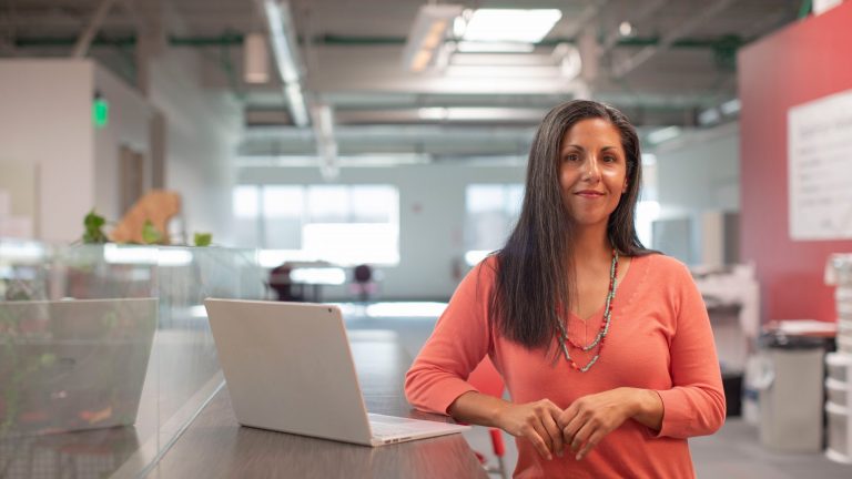 business women standing by computer in workplace