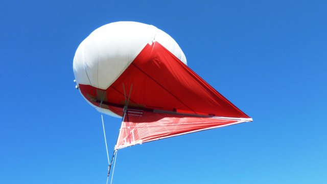 a Helikite is a tethered balloon with kite elements that enhance its lifting capacity (image from https://www.uasvision.com/)