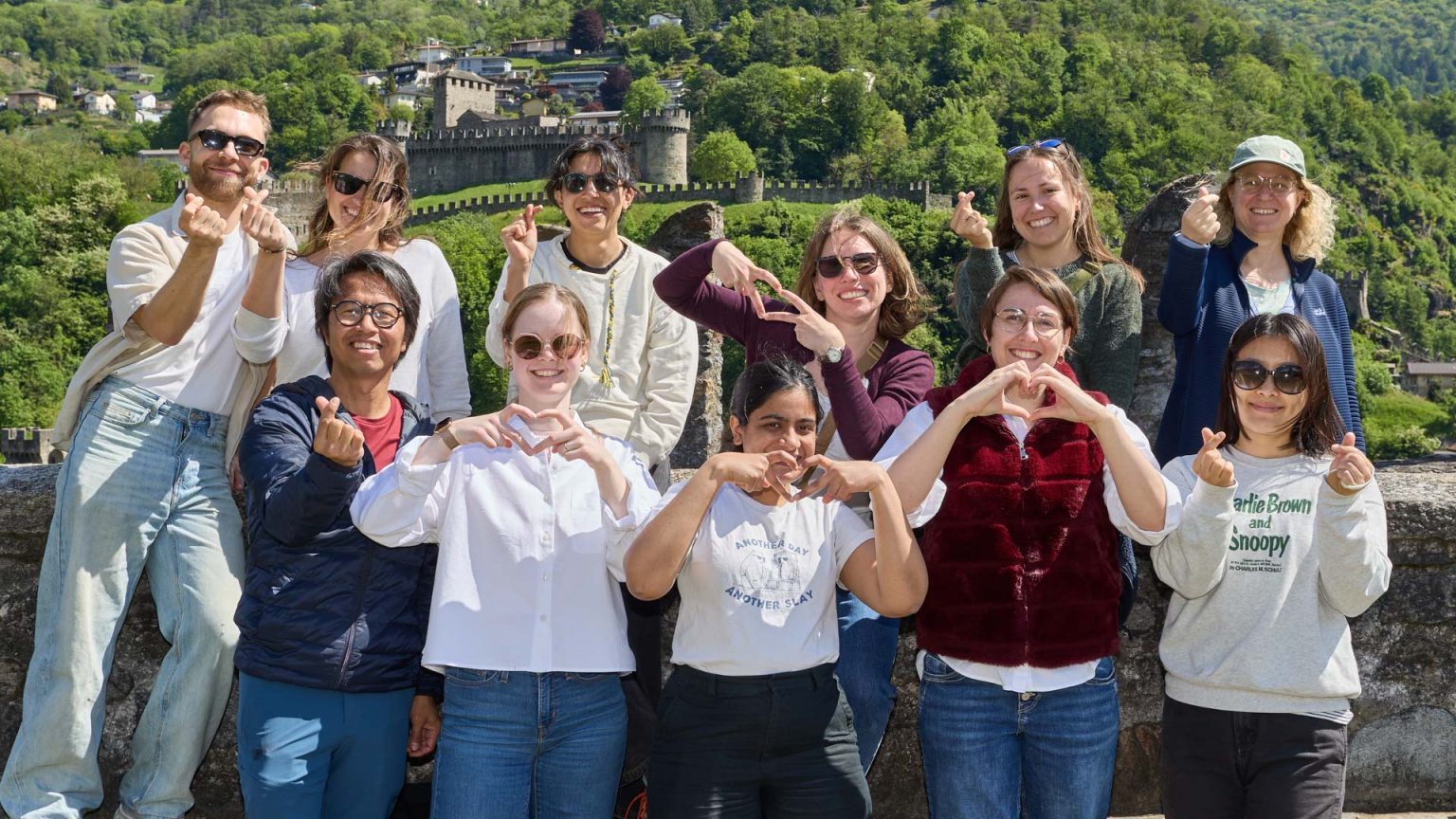 11 members of LEV team during their visit to Castel Grande at Bellinzona in Ticino, showing different heart shapes.