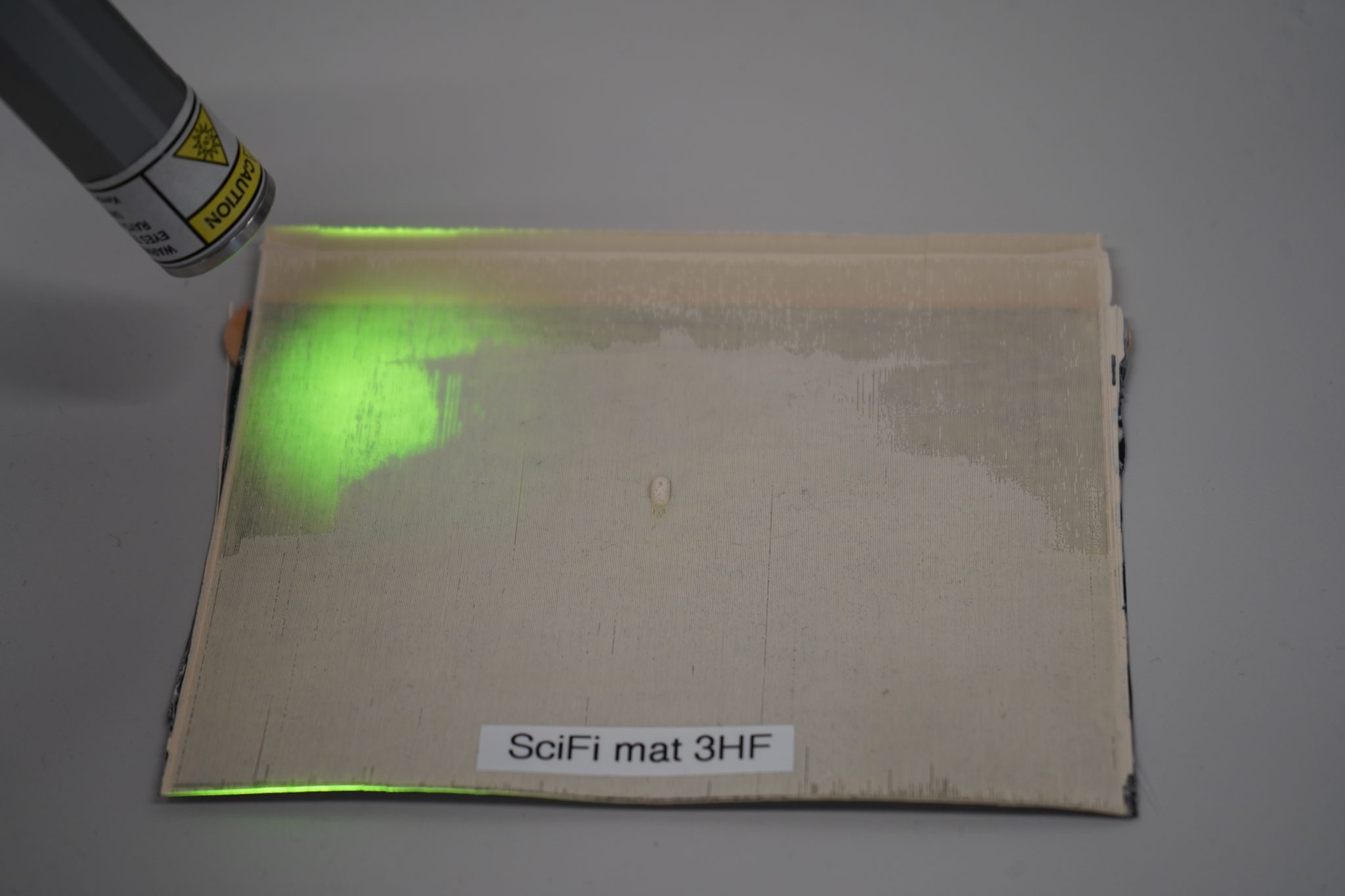 Scintillating-fiber mat and its behavior under ultraviolet light.