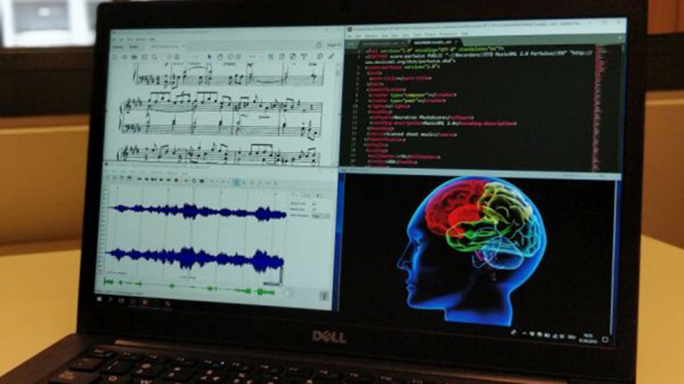 Close up of computer screen with music notes and a brain in colour